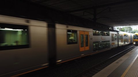 St leonard, NSW / Australia - Nov 09 2019:  Sydney Train heavy rails enter station. passenger commuters waiting arrive at platform. guard station and infomation board available evening. TfNSW