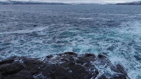 Big waves of arctic ocean aerial video. Drone view on blue epic ocean, clean water, breaking waves, whitewash. Ocean seascape, wildlife north pole, polar sea. Climate change and global warming.