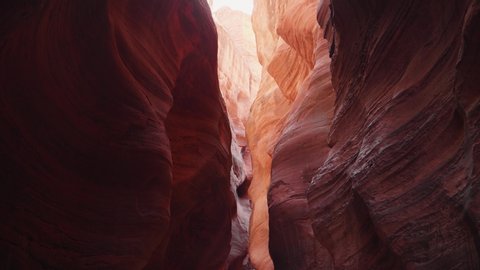 Buckskin Gulch deep slot canyon with wavy and smooth stone massive vertical walls of red orange color, amazing rock formations antelope canyon, fantastic place to photograph. Utah Usa, camera movement