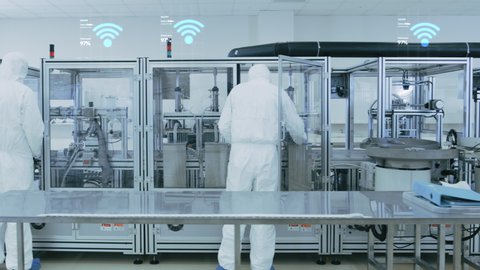 Manufacturing Facility Workers Assembling Products Using Industrial High Precision Machinery. Special Effects Animation: Wi-Fi Connected Icons with Completion Progress. Industry 4.0 Concept of IOT