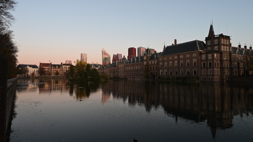 Sunset on the Dutch parliament reflected on the pond calm water, The Hague, Netherlands