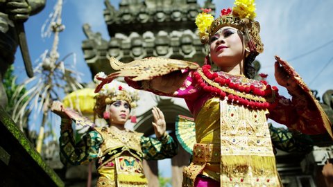Balinese Hindu temple beautiful females performing ancient tradition part of religious and artistic dance expression among the people of Bali Indonesia travel and tourism RED MONSTRO