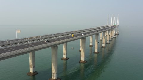 QINGDAO, CHINA – SEPTEMBER 2019: Ascending drone flight of Jiaozhou Bay Bridge in Qingdao, one of the largest bridges over water in the world, infrastructure development in China