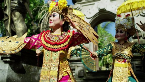 Balinese Hindu temple beautiful females performing ancient dance tradition part of religious and artistic expression among the people of Bali Indonesia travel and tourism RED MONSTRO