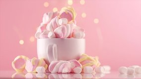 Marshmallow. Close-up of Marshmallows colorful chewy candy, rotation over pink background. Sweet food dessert in a cup with hot chocolate close-up. 4K UHD video 