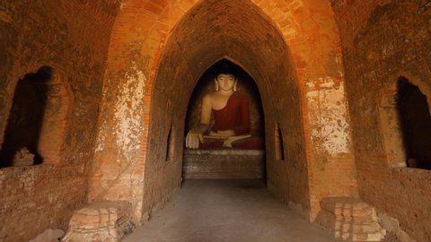 Old Buddha Statue in Traditional Burmese Temple. Buddhism Religion Concept Footage. 4K Slowmotion Steadycam Shot. Bagan, Myanmar.
