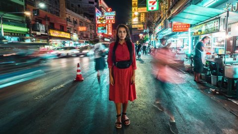 Young Mixed Race Tourist Woman Standing at Busy Crowded Street in Chinatown. People Passing By. 4K Wide Angle View Timelapse. 15 NOV 2019 - Bangkok, Thailand.