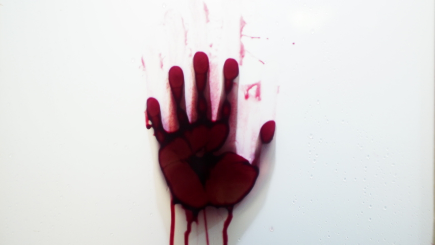 Bloody hand against blured wet shower glass. Horror scene