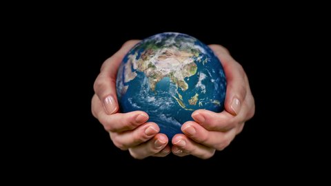 Female hands holding a rotating hyperrealistic Earth over black background. 