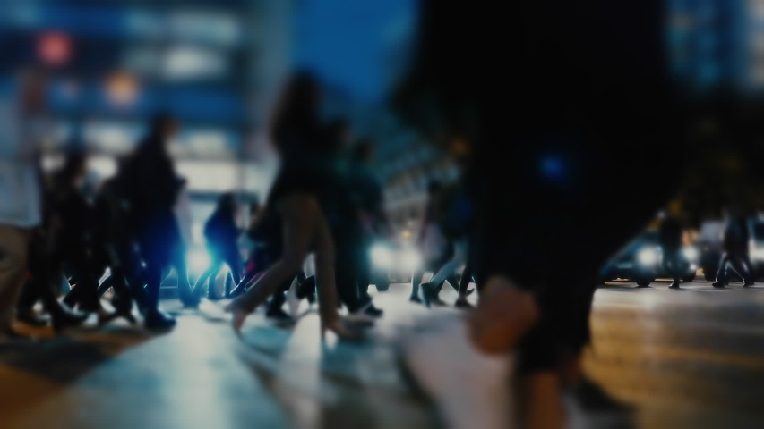 People and shoppers cross a busy city street.People and traffic in a busy European city at night. Royalty-Free Stock Footage #1041061742