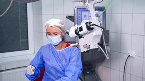Surgeon Using Operating Microscope During Work. Video from the side. Selective video focus on special ophtalmology Modern equipment and doctor's work.