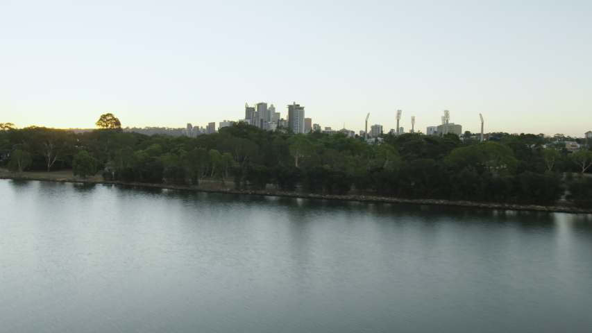 Aerial sunset view Heirisson Island nature reserve with vehicles travelling from East Perth over Causeway Bridge Western Australia