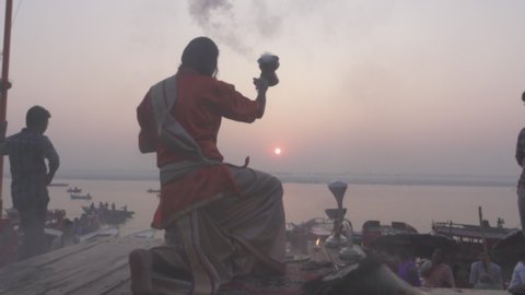 Varanasi, India - CIRCA 2019: Benares Holy Spiritual city on the banks of the river Ganges Ganga Uttar Pradesh India Morning Mist People Praying Artii