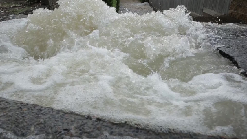 A burst water mains pipe at West st Burleigh Heads causes flash flooding of apartments and nearby streets on the Gold Coast Queensland Australia. 