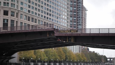 Chicago, IL - November 2nd, 2019:  The Columbus Street draw bridge slowly lifts to a vertical position to let tall boats through the Chicago River on a cold fall morning.