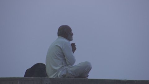 Varanasi, India - CIRCA 2019: Benares Holy Spiritual city on the banks of the river Ganges Ganga Uttar Pradesh India Morning Mist People Activity Praying Meditation