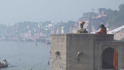 Varanasi, India - CIRCA 2019: Benares Holy Spiritual city on the banks of the river Ganges Ganga Uttar Pradesh India Morning Mist People Activity Praying Meditation Sadhu Smiling Portrait