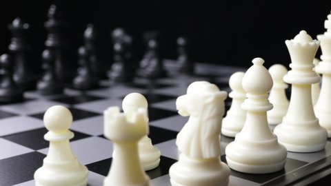 white plastic chess figures close up camera movement