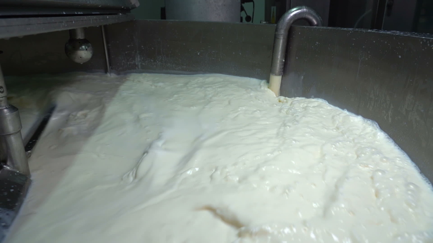 Milk Pasteurization in Dairy Processing Plant. Milk inside the Pasteurization Tank at the Dairy Factory. Raw Milk Pouring into Pasteurization Tank in Slow Motion. Dairy Plant Food Safety. Royalty-Free Stock Footage #1041086680