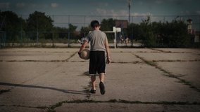 Kid on a ghetto soccer field court playing football and kicking ball - Powered by Shutterstock - Get 15% off with code: PIKWIZARD15