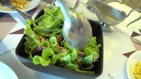 Video clip close up mixing salad by fork and spoon, healthy food dish