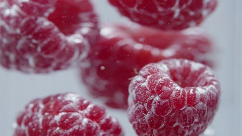 Raspberries in the water close up