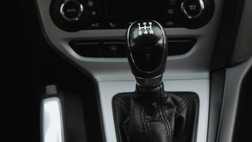 Driver man controls auto and switch gears, then shifts to neutral gear and pulls the handbrake handle, close-up shot | Shutterstock HD Video #1041094708