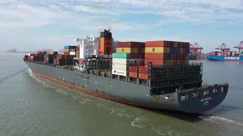 SHANGHAI, CHINA – SEPTEMBER 2019: Flying from stern towards the bow of a large container vessel arriving at the Port of Shanghai in China