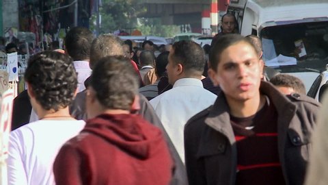 CAIRO, EGYPT - DEC 2011: Car traffic and pedestrians at a busy street