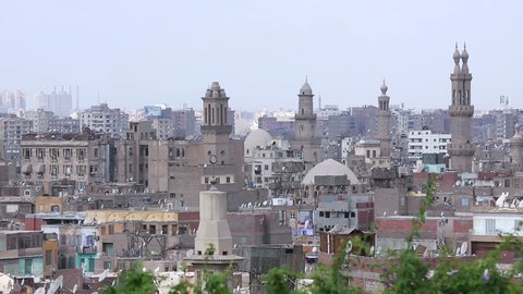 Muizz street's famous mosques with Cairo skyline, Egypt. Muizz is one of the oldest streets in Cairo which has the greatest concentration of medieval architectural treasures in the Islamic world