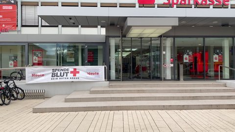 Kehl, Germany - Circa 2019: Invitation to donate blood at the red cross banner in front of Sparkasse bank with Man truck - spende blut beim roten kreuz