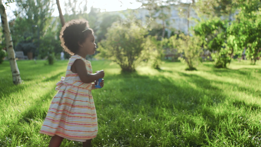 Close up of african-american girl with diadem on head eating cotton candy