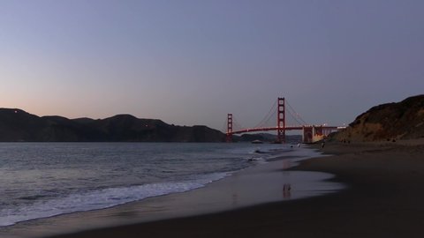 The Golden Gate Bridge as seen from Baker Beach at sunset, San Francisco, California, USA