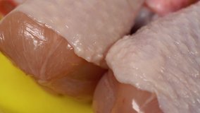 Closeup view of uncooked fresh chicken legs. Video footage.
