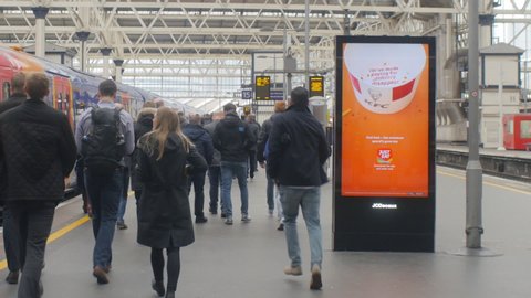 London / United Kingdom (UK) - 12 11 2018: Digital vertical advertising display by JCDecaux at a London Waterloo station which is the largest railway station in the United Kingdom.