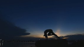 Silhouette video Young asian woman yoga outdoors keep calm and meditates while practicing yoga to explore the inner peace.