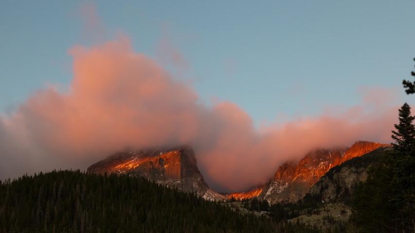 Time Lapse of the clouds moving above the rugged mountains in the Rocky Mountains National Park in Colorado USA.