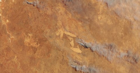 Very high-altitude overflight aerial of wildfires raging across the Goldfields Region, western Australia. Clip loops and is reversible. Elements of this image furnished by NASA