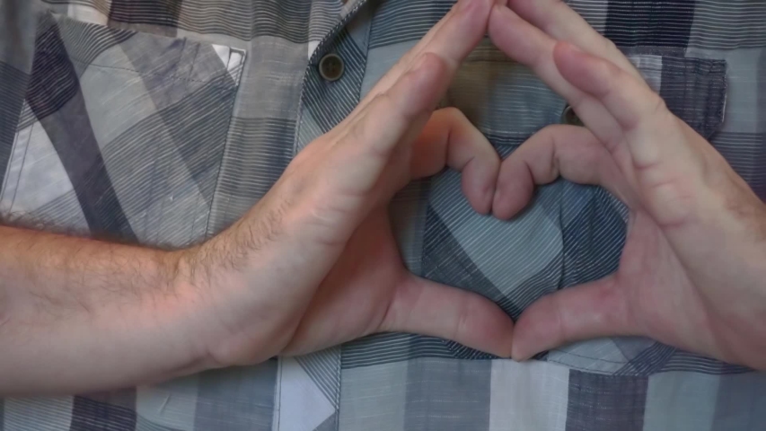 Europian young man making gest hands in heart shape, heart health insurance, social responsibility, donation charity concept, world heart day, International Day of Sign Languages. | Shutterstock HD Video #1041148090