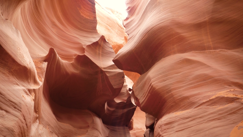Movement on the antelope canyon with wavy and smooth sandstone walls of bright red orange color, amazing rock formations in Arizona desert, beautiful famous place to photographed Royalty-Free Stock Footage #1041157723