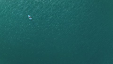 Aerial view of a fishing boat in the blue sea