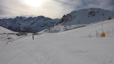 Ponte di Legno, Tonale, Italy. Skiing on the slopes in a wonderful day. POV from the skier. Point of view from the ski helmet. Italian Alps