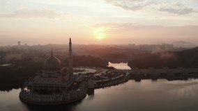 Aerial view of Putra Mosque at sunrise in Putrajaya, Malaysia. Panning to the right.