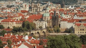 Prague, Czech Republic - September 2019: Elevated city view with people walking on Charles Bridge. 4K resolution speed up.