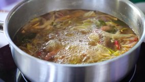 Cooking Video Tom Yum is boiling in the pot.Tom Yum is a Thai spicy flavor Consists of fresh ingredients including lemongrass, kaffir lime leaves, lemon fish sauce and chilli Tom Yum is famous dish