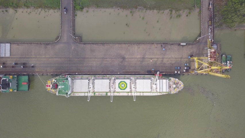 A top down view of a cargo ship loading at a sea port at Kuching, Sarawak, Malaysia
