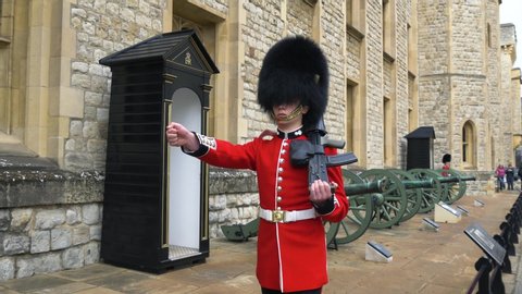 London, UK - April, 2019: British soldier guards the territory of the Tower of London. Marching Guards in the Tower of London. British guardsman in traditional red-black uniform. British soldier.
