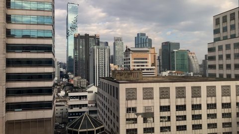Bangkok, Thailand, November 2019: Time lapse clouds moving over skyscrapers in Bangkok 