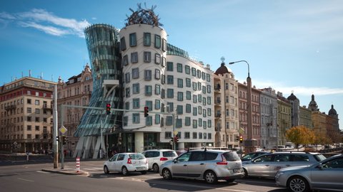 Prague, Czech Republic - October 17, 2019: Dolly left time lapse shot of traffic in front of architectural landmark Dancing House aka Fred and Ginger by day in Prague, Czech Republic. 