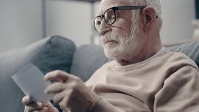 Senior man with dementia looking at photos